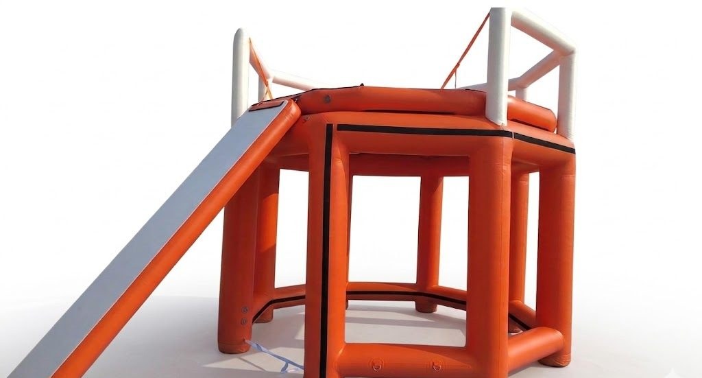 Orange inflatable observation tower product render with access ramp and guard rails