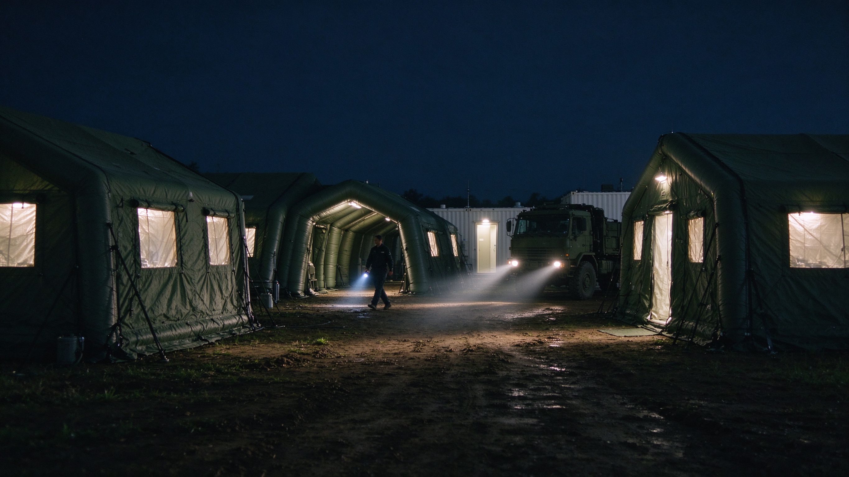 Inflatable hospital camp lit from inside at night